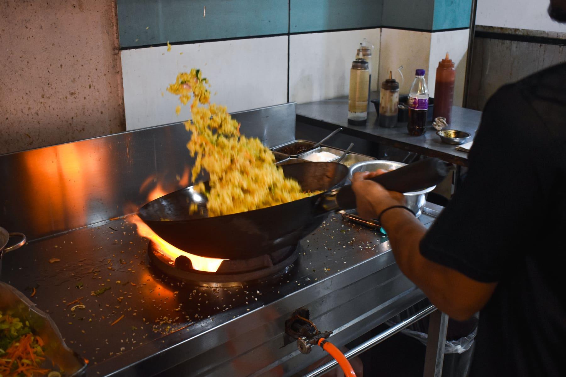 Fried rice tossed over an open flame in the Food Cabin kitchen